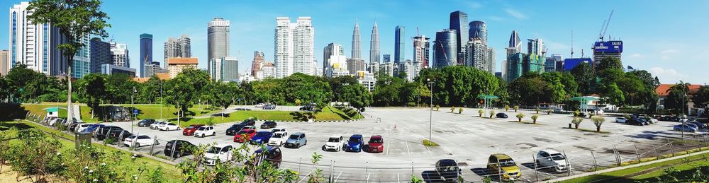 Panoramic view of people on road in city