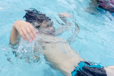 Boy swimming in pool