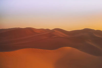 Scenic view of desert against sky during sunset