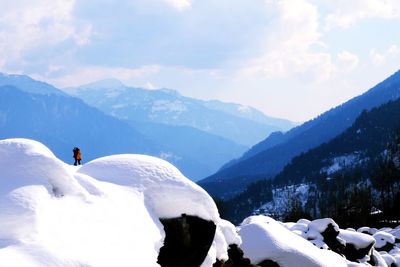 Silhouette couple standing of snowcapped mountains against sky during winter