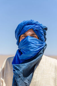 Portrait of man wearing headscarf