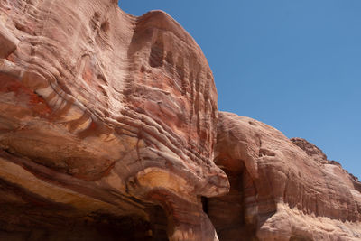 Low angle view of rock formation against sky