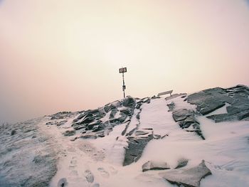 Mountain snowy peak hidden in heavy mist. extreme weather. dramatic landscape. vinyage retro filter