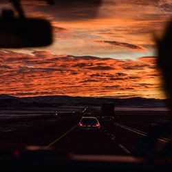 Car on road at sunset