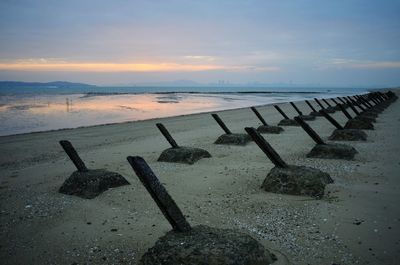 Scenic view of beach against sky during sunset