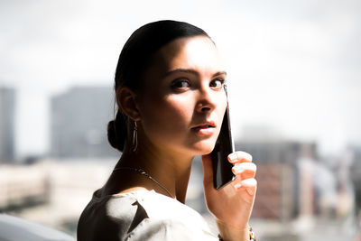 Portrait of beautiful woman in city