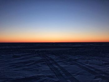 Scenic view of sea against clear sky at sunset