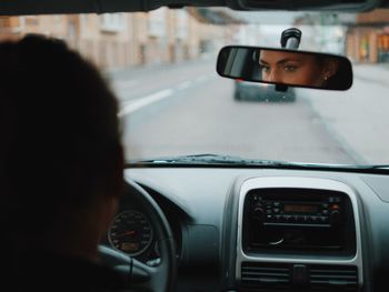 Woman driving car on road