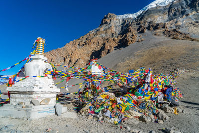 Multi colored prayer flags against mountain range