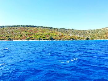 Scenic view of sea against clear blue sky