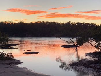 Scenic view of lake against sky during sunset