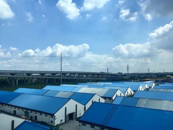High angle view of buildings against blue sky