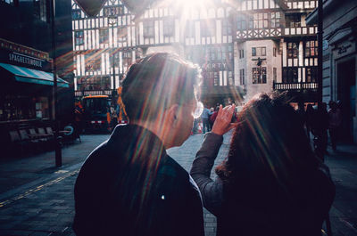 People on city street amidst buildings