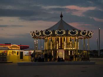 Illuminated ferris wheel at night