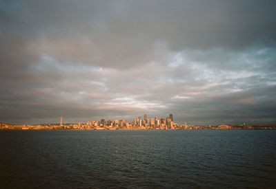 Sea against buildings in city