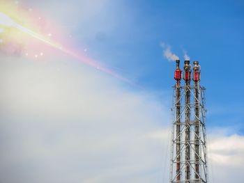 Low angle view of communications tower against sky