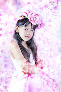 Portrait of beautiful woman with pink flower