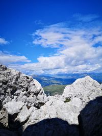 Scenic view of rocky mountains against blue sky