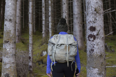 An anonymous hiker walking into the deep dark forest