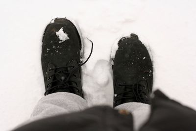Low section of person standing on tiled floor