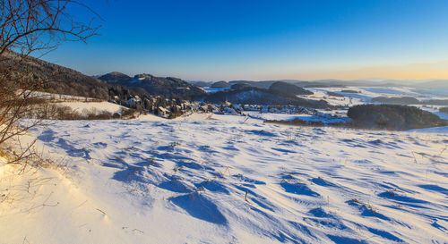 Scenic view of landscape against blue sky