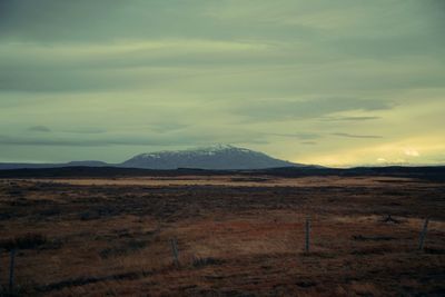 Scenic view of mountains against cloudy sky