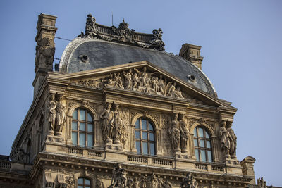 Low angle view of historical building against blue sky