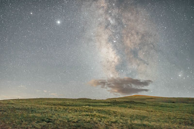 Scenic view of field against sky at night