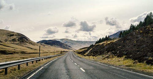 Road amidst mountains against sky