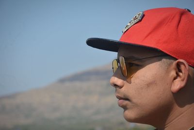 Portrait of man looking away against sky