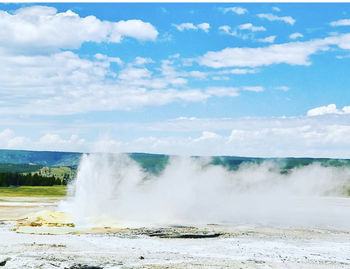 Scenic view of waterfall against sky
