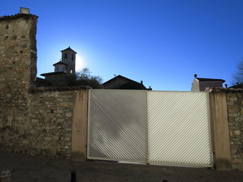 Low angle view of buildings against clear blue sky