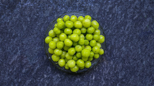 High angle view of green fruits on black background