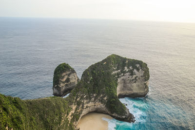 High angle view of rocks on sea against sky