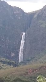 Scenic view of waterfall against sky