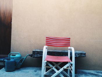 View of empty chair next to wall