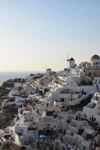 High angle view of townscape by sea against clear sky