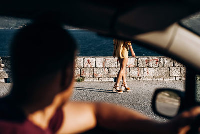 Close-up of man looking at woman from car window