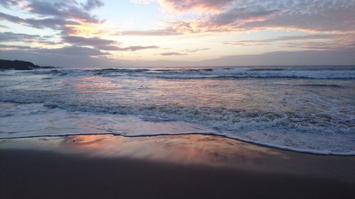 Scenic view of sea against cloudy sky