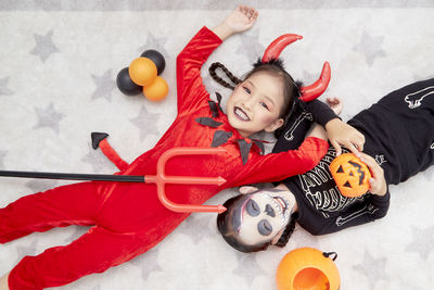 High angle view of baby girl with toy on floor