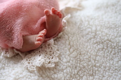 Close-up of baby lying on bed