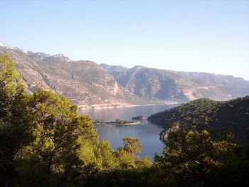 Scenic view of lake and mountains against clear sky