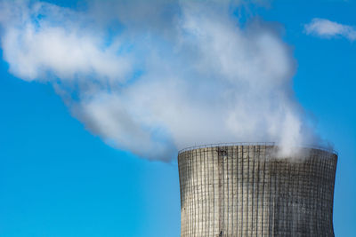 Low angle view of smoke stack against sky