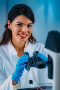 Biology student researcher looking through the microscope