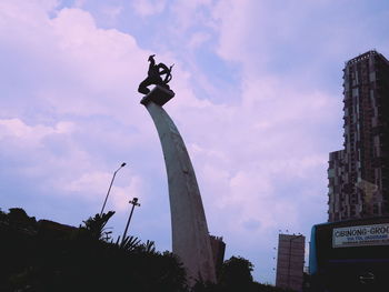 Low angle view of statue against cloudy sky