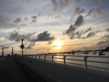 Road against cloudy sky at sunset