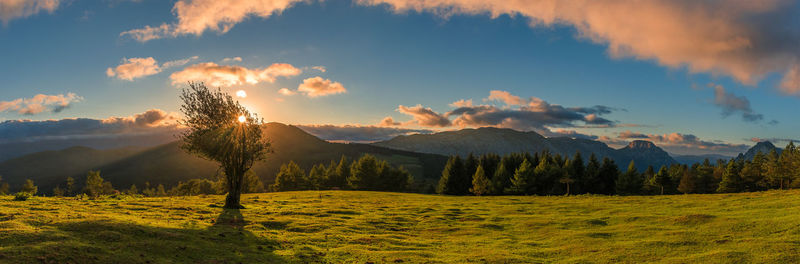 Scenic view of land and mountains against sky