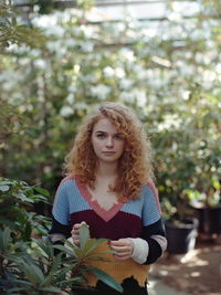 Portrait of young woman sitting outdoors