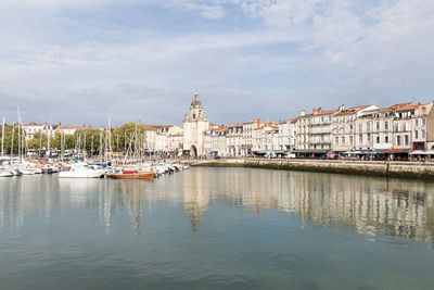 Boats in river against sky