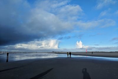 Man standing on beach against sky